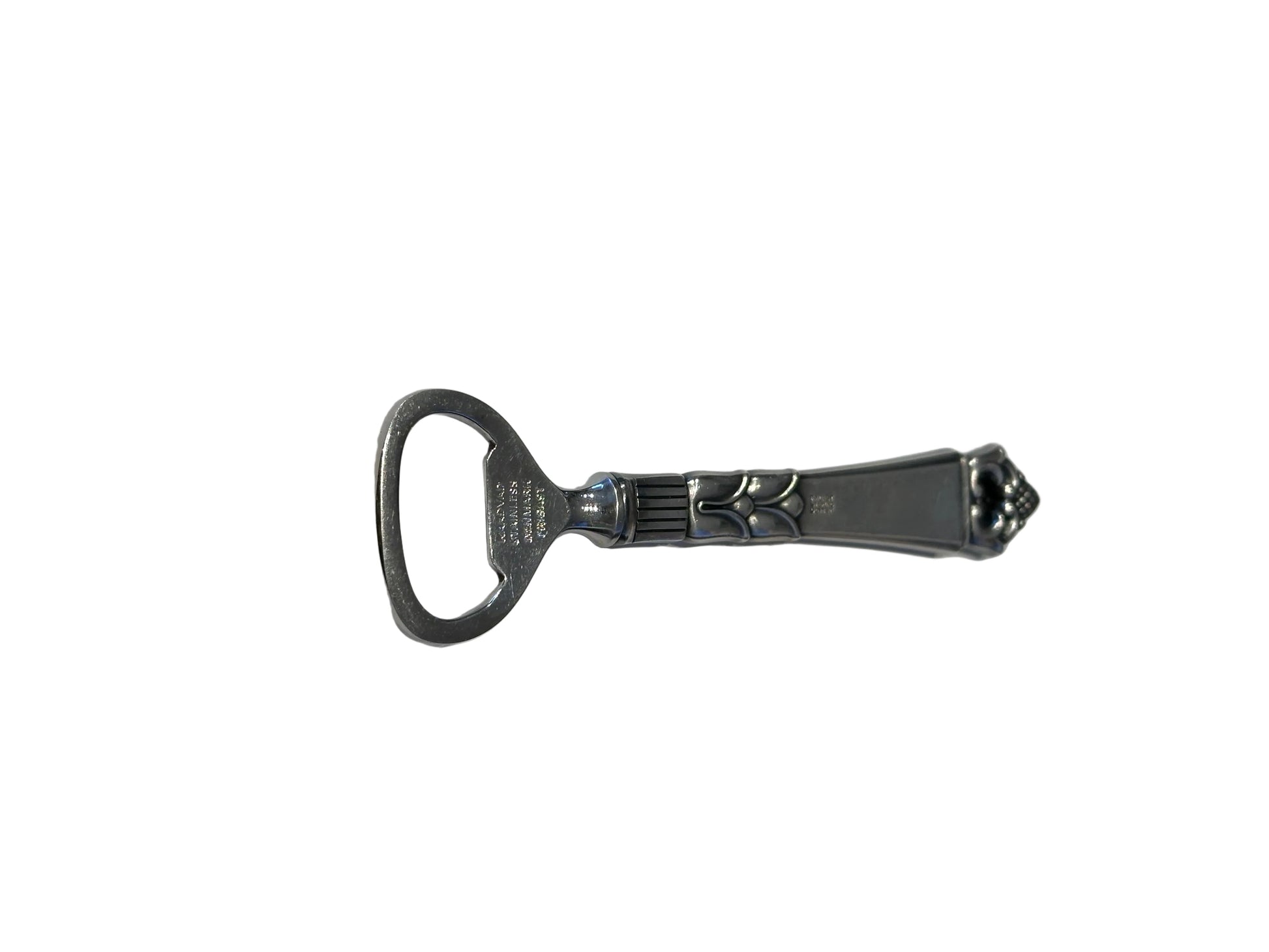 Danish sterling bottle opener shown horizontally, ornate handle and stainless opener