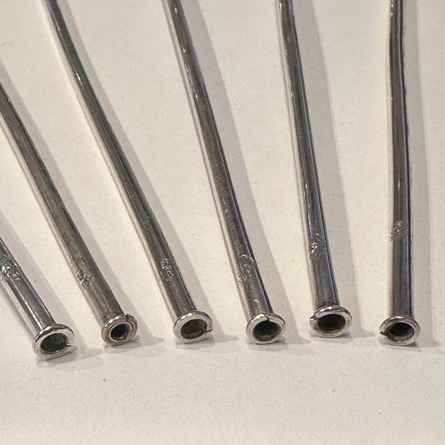 Close-up of the hollow straw ends of the sterling silver sipper handles