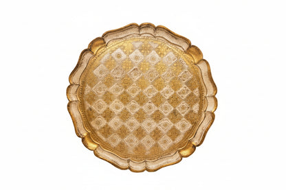 Round Florentine tray with gold checkerboard and floral pattern on scalloped rim, top view.