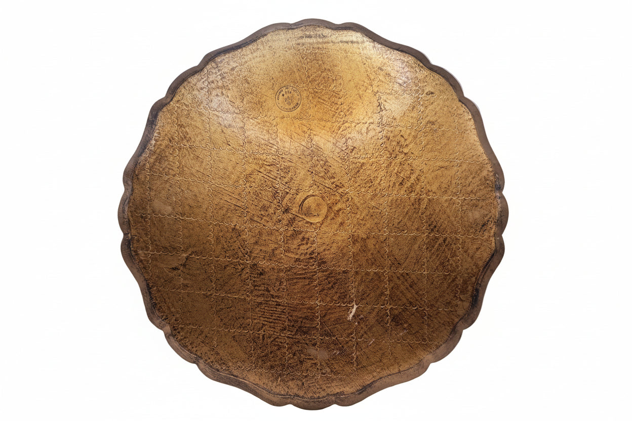 Back of round Florentine tray showing worn gilt underside with scalloped edge.