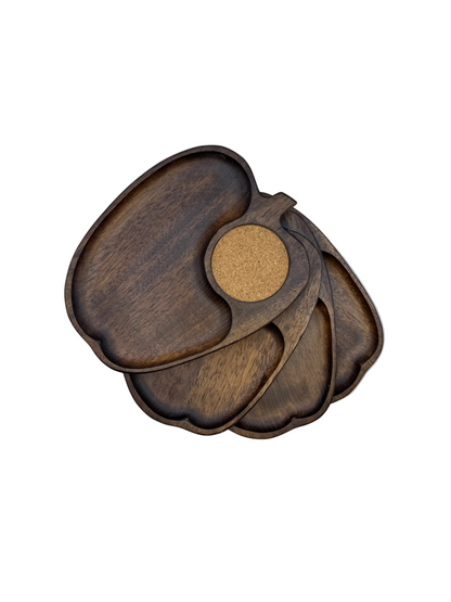 Set of vintage apple-shaped wooden snack trays with cork coaster wells, fanned in a stack