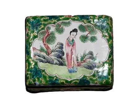 Top view of the enamel box lid, painted lady standing in a garden within a scalloped reserve