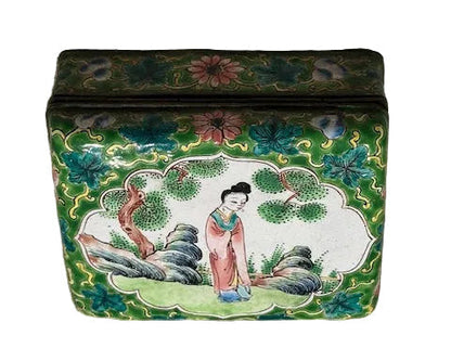 Front panel of the enamel hinged box, lid scene of a lady in a garden with floral borders