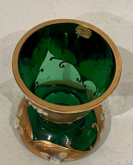 Angled top view of the emerald green vase showing gilt rim, green interior and label