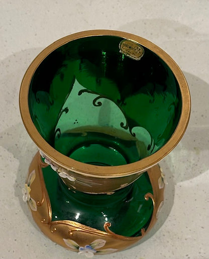 Angled top view of the emerald green vase showing gilt rim, green interior and label