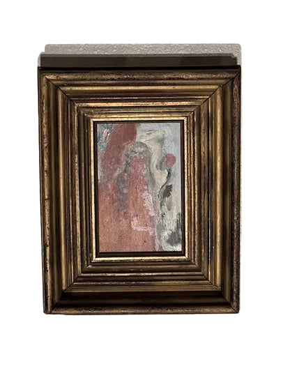 Angled view of the framed J. Dunn abstract oil on board in its ornate vintage gold frame