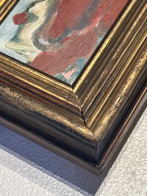 Close-up of the antique gilded frame corner showing worn gilt molding and the painting's edge