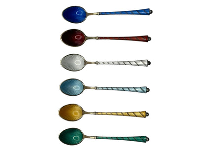 Six Ela of Denmark enamel demitasse spoons shown horizontally, twisted handles, bowls in blue, red, white, teal, yellow.