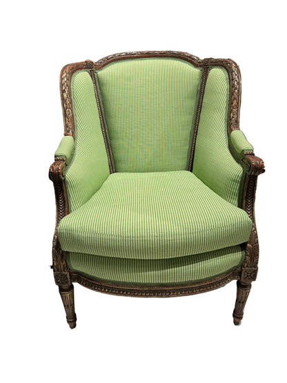 Antique Louis XV style bergere armchair with green striped upholstery and carved wood frame