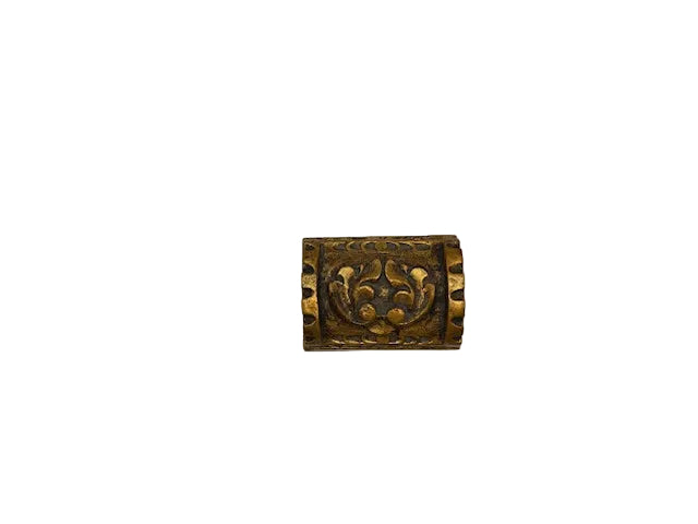 Close-up of the carved gilt floral medallion on the lid of the wood box.