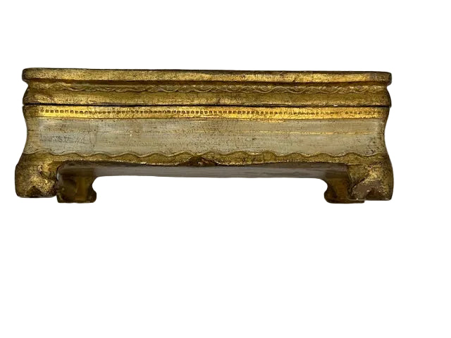 Side of gilded Florentine box, closed lid, scalloped apron and scrolled bracket feet