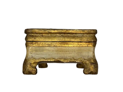 Front of cream and gilt Florentine box with scalloped apron and bracket feet