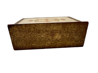Angled view of Florentine letter holder showing wood-grain sides and floral painted top edge