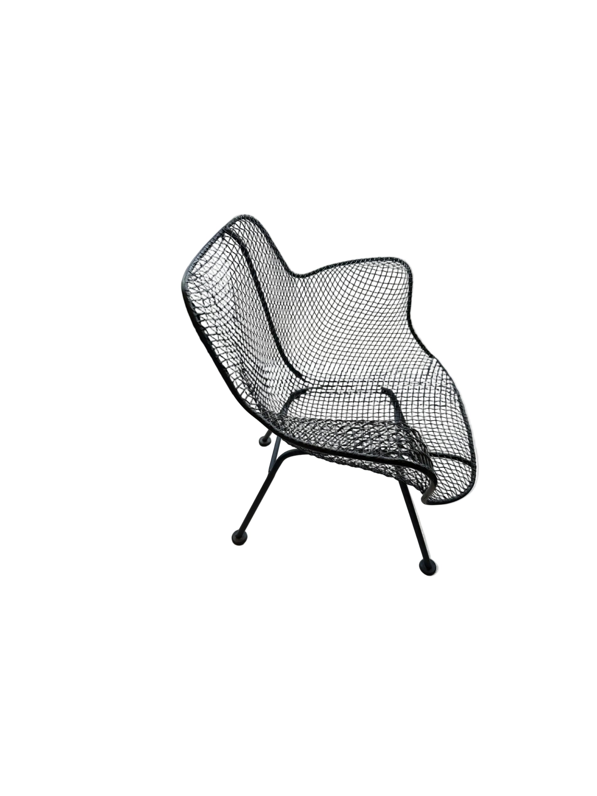 Russel Woodard wire-mesh chair, three-quarter front view on iron legs with ball feet
