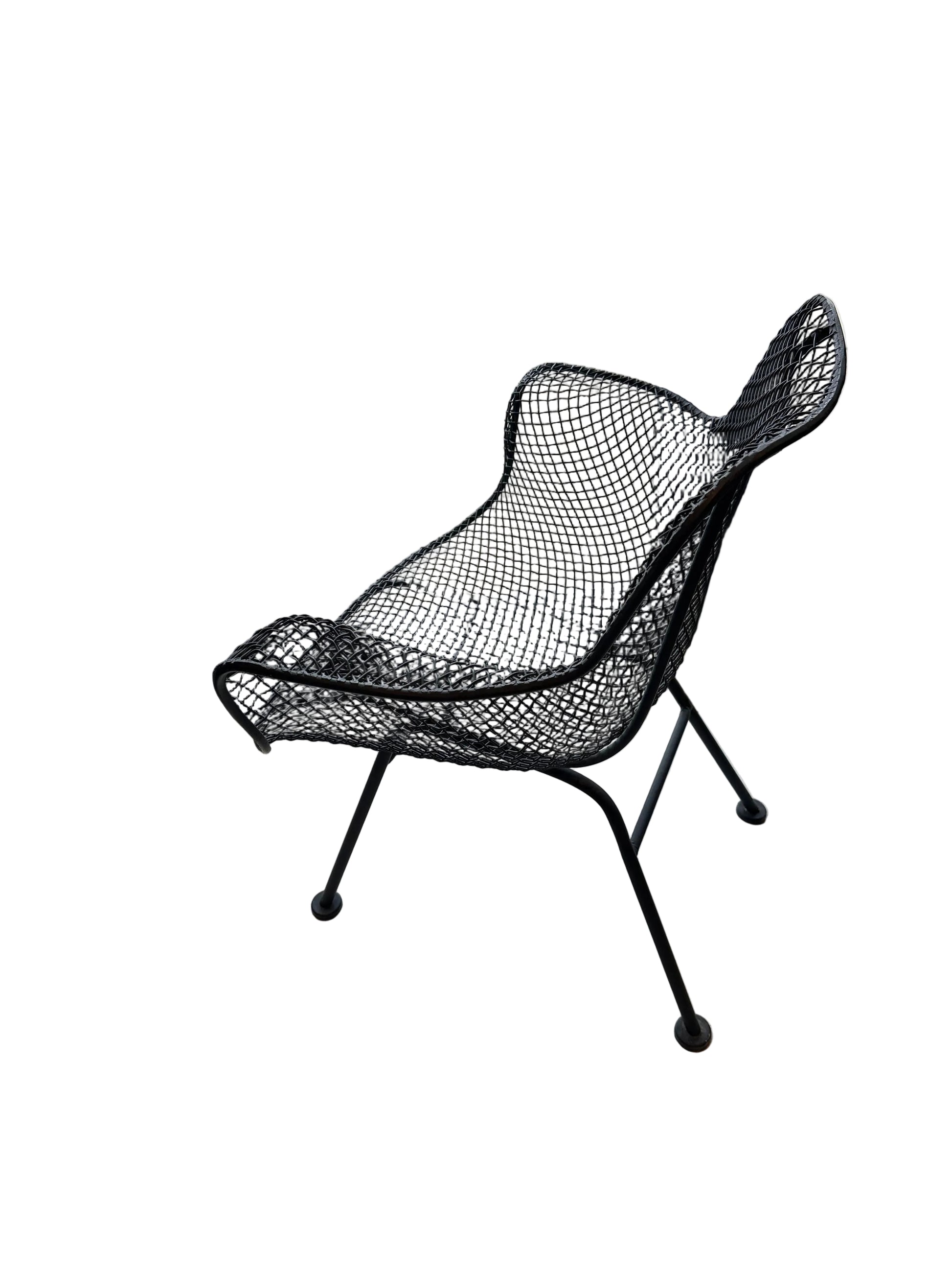 Side profile of black wire-mesh Russel Woodard Sculptura chair