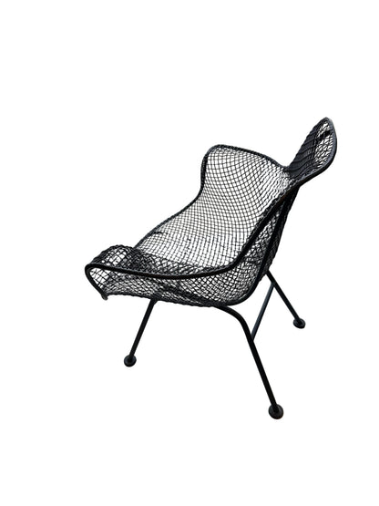 Side profile of black wire-mesh Russel Woodard Sculptura chair