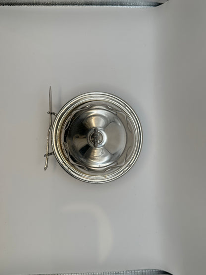 Top view of silverplate caviar dome lid and spreader knife