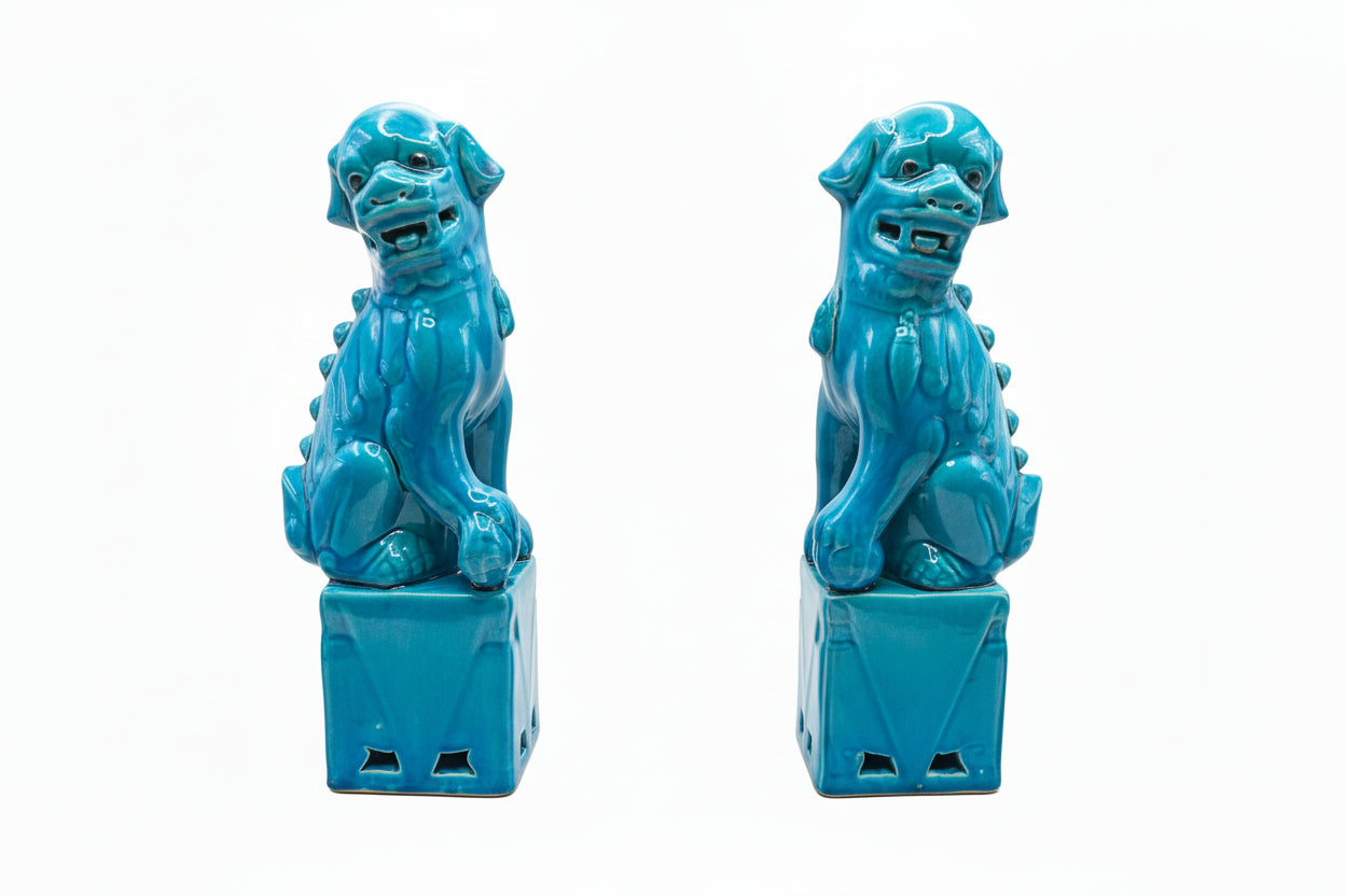 Pair of turquoise glazed ceramic foo dogs, profile view facing each other