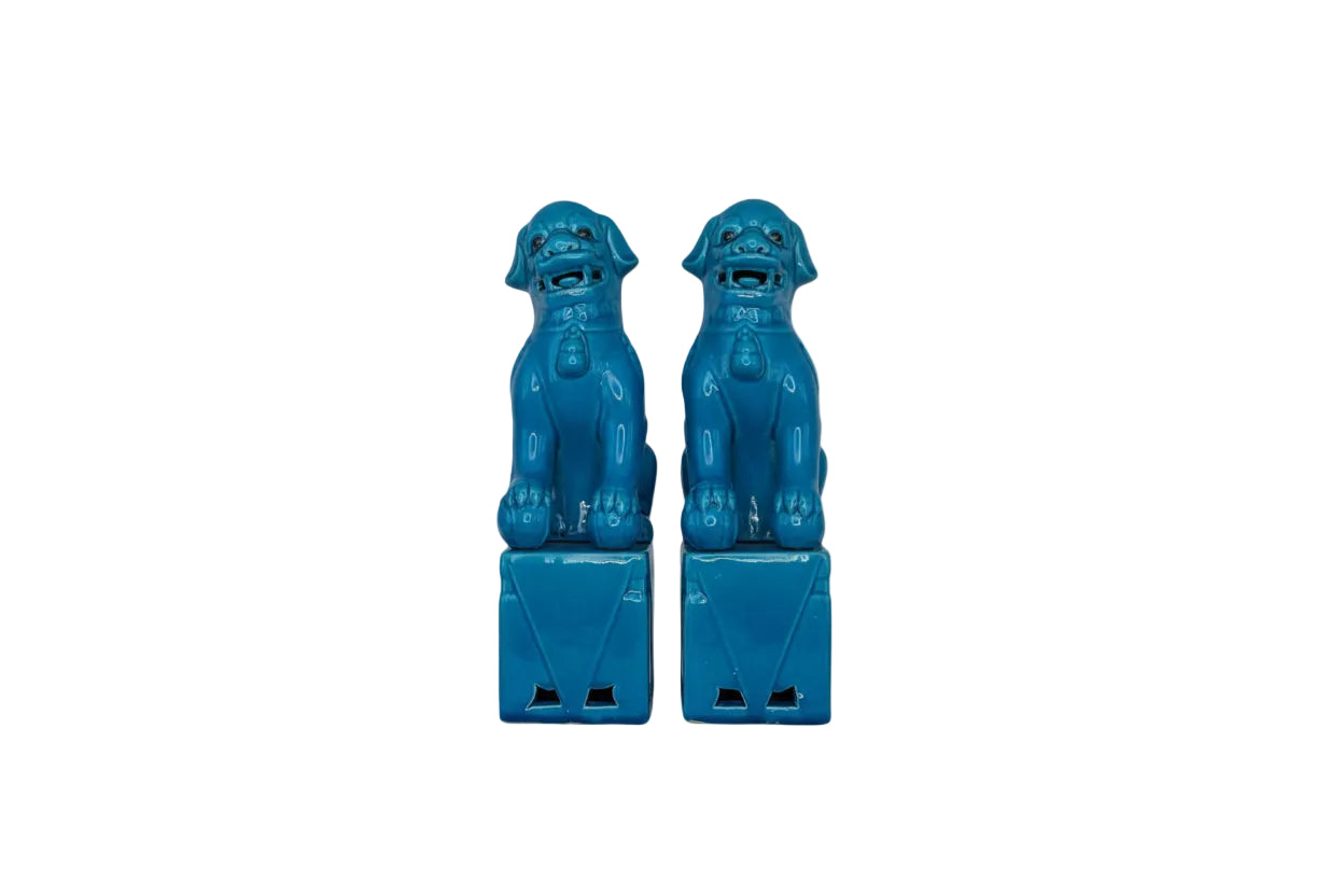 Pair of turquoise glazed ceramic foo dogs seated on plinths, front view