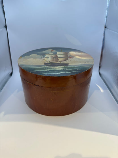 Round papier-mache box with sailing schooner painted on the lid, side view