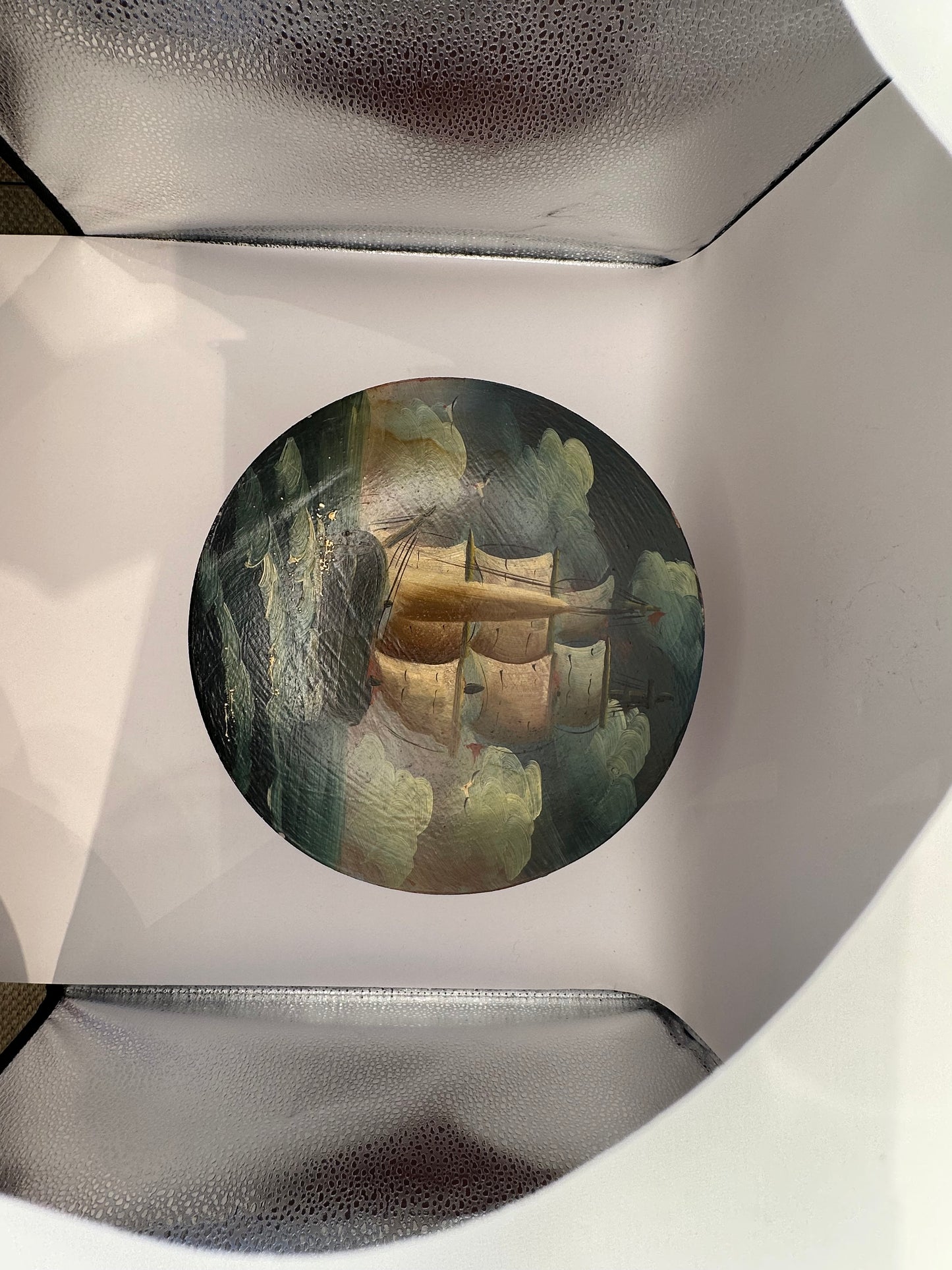 Painted lid depicting a schooner in stormy seas, top view