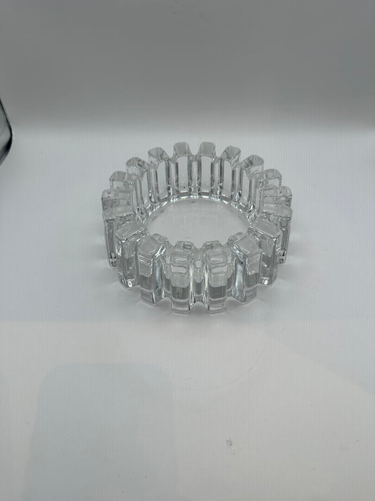 Vintage MCM heavy clear glass dish with blocky notched rim, three-quarter view