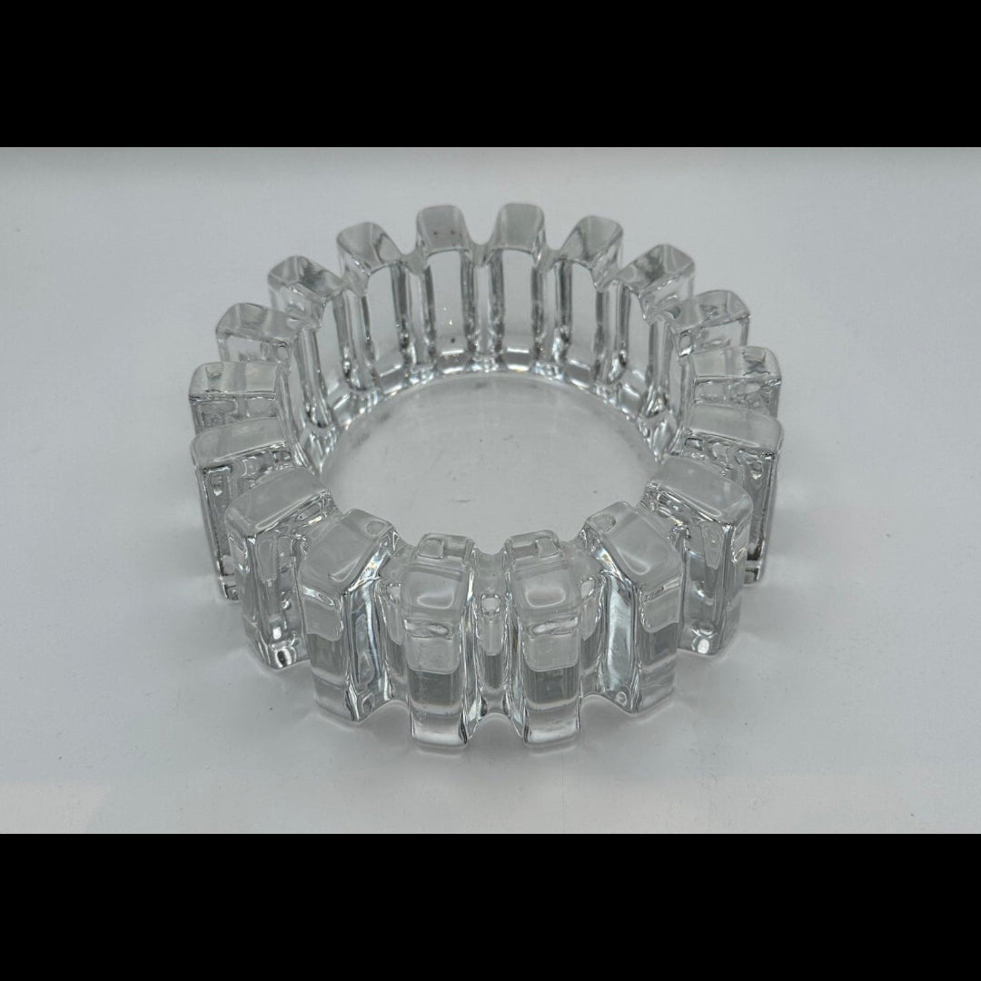 MCM notched clear glass dish viewed lower angle, highlighting blocky cut pattern