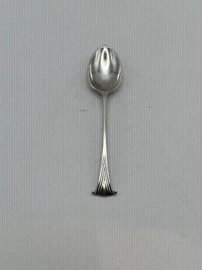 Single silverplate demitasse spoon, front view, oval bowl and slender handle with fanned scroll terminal