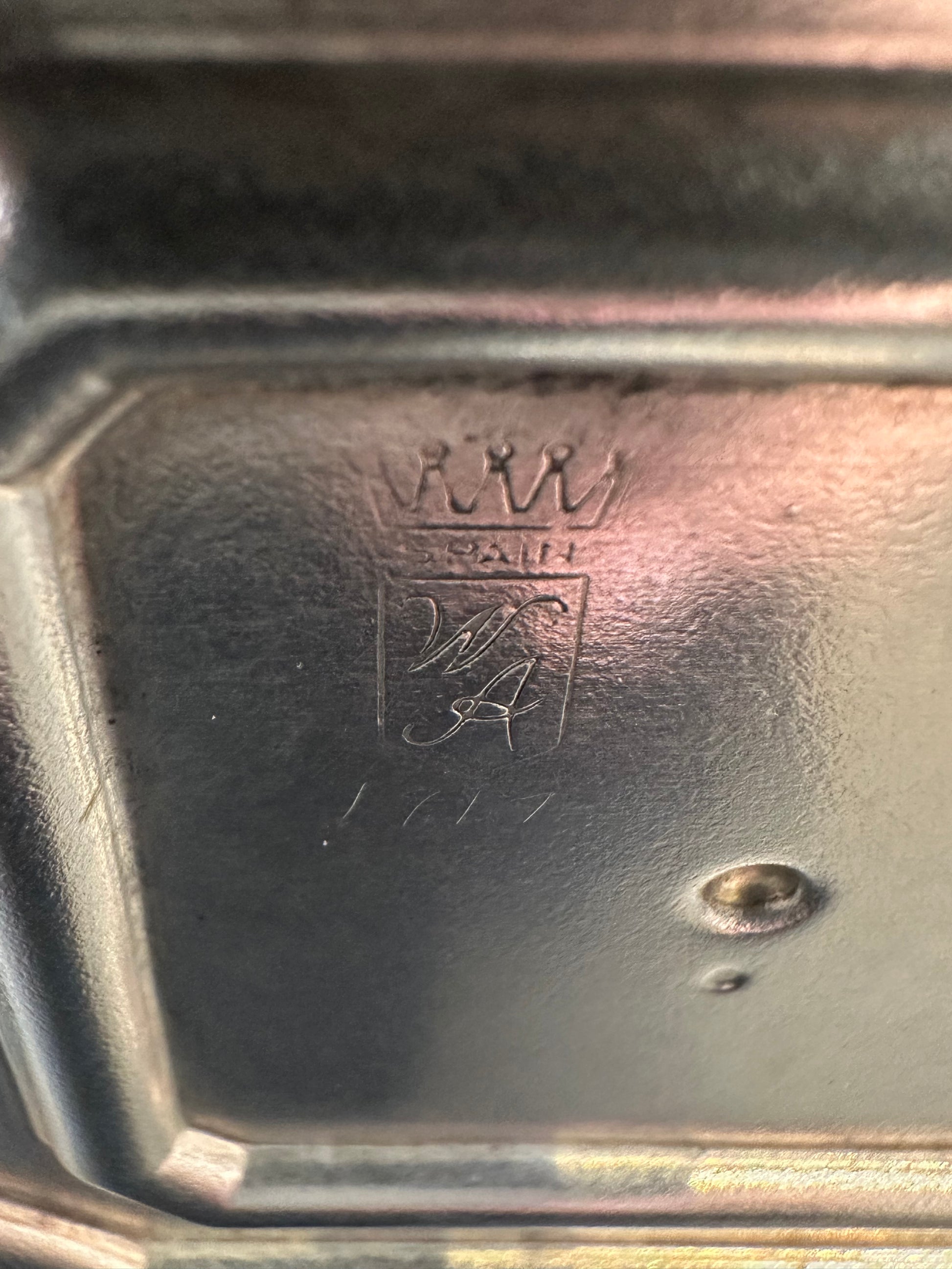 Close-up of candlestick base engraving, crowned Spain shield with W.A. monogram hallmark