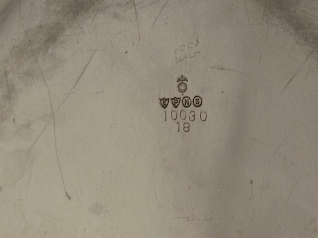 Underside of silver plate tray showing maker's hallmarks, shields and number 10030