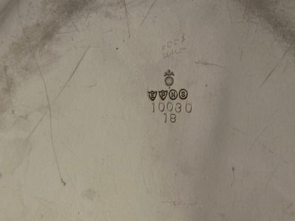Underside of silver plate tray showing maker's hallmarks, shields and number 10030