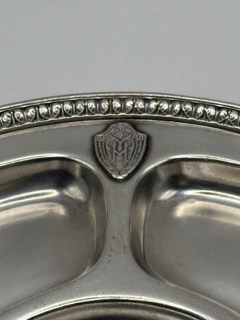 Close-up of Gorham divided tray rim with beaded edge and engraved monogram shield