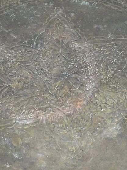 Close-up of vintage brass tray center showing engraved dragon and foliate detailing
