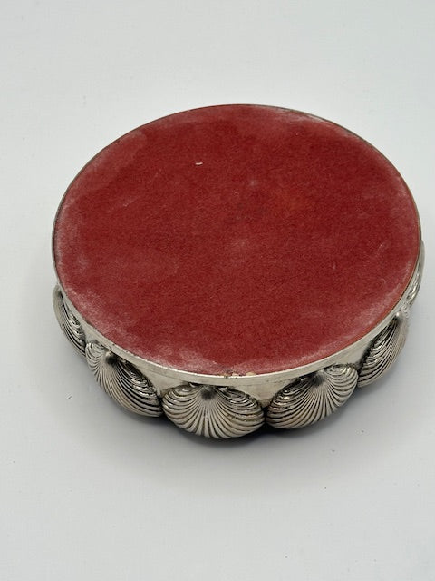 Top view of shell-design bottle coaster showing reddish-brown wood base