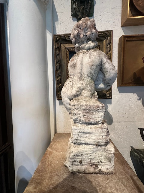 Concrete Autumn cherub statue, side profile on a marble-topped stand