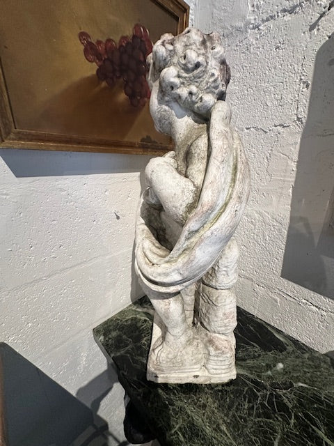 Back view of concrete Four Seasons cherub statue showing draping and weathered surface