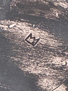 Close-up of bowl's dark unglazed base showing engraved maker's mark.
