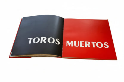 Vintage book Toros Muertos, open to black and red title spread in white lettering