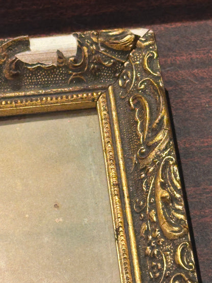 Detail of "Infant Jesus" gilt frame corner showing chipped ornamental gesso and loss to gold leaf
