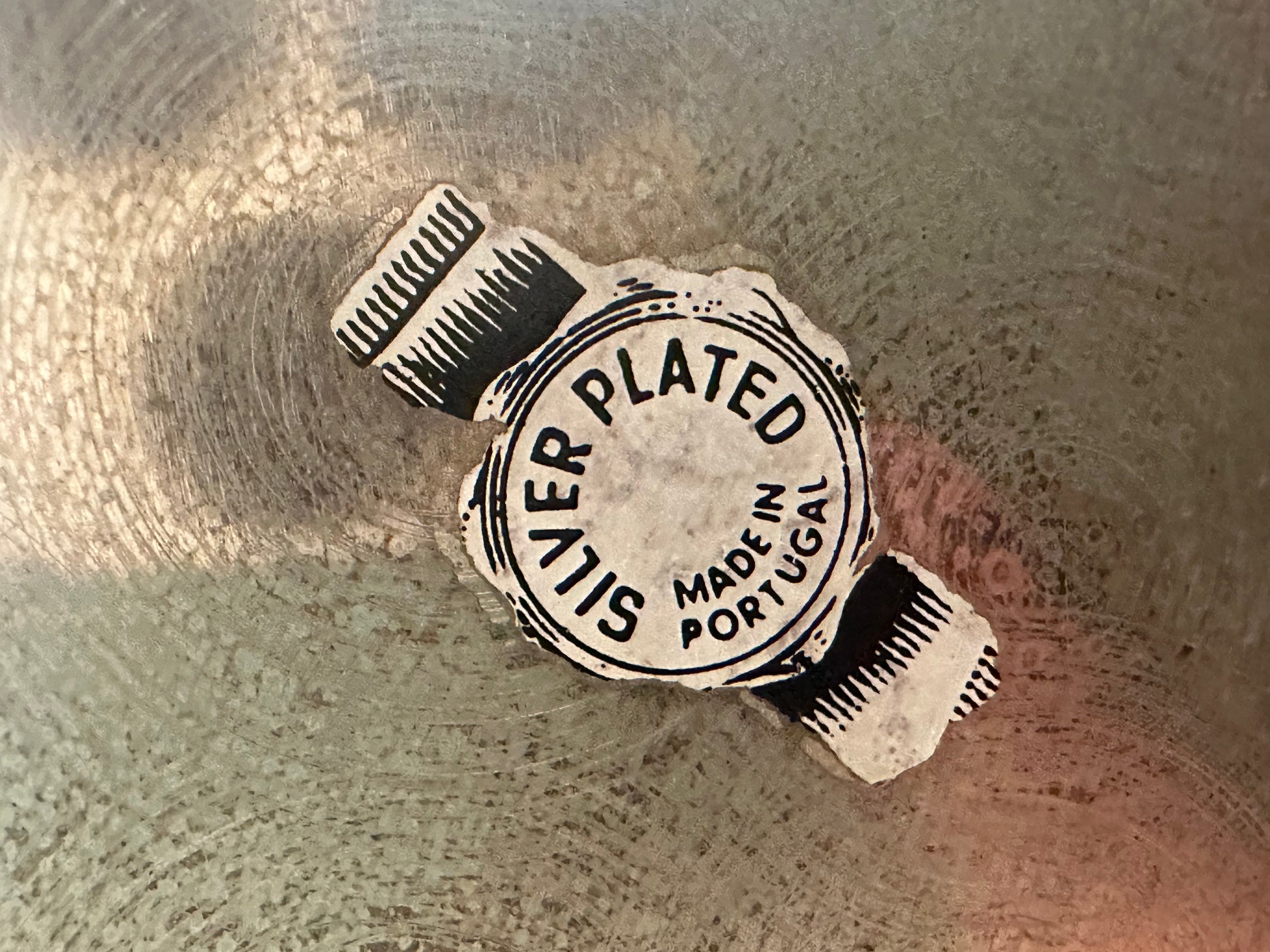 Close-up of maker's mark reading Silver Plated, Made in Portugal on the swan's base