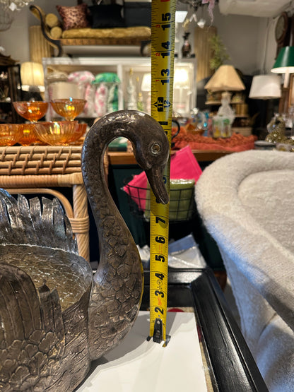 Swan jardiniere with tape measure showing neck height near 15 inches in a furnished room