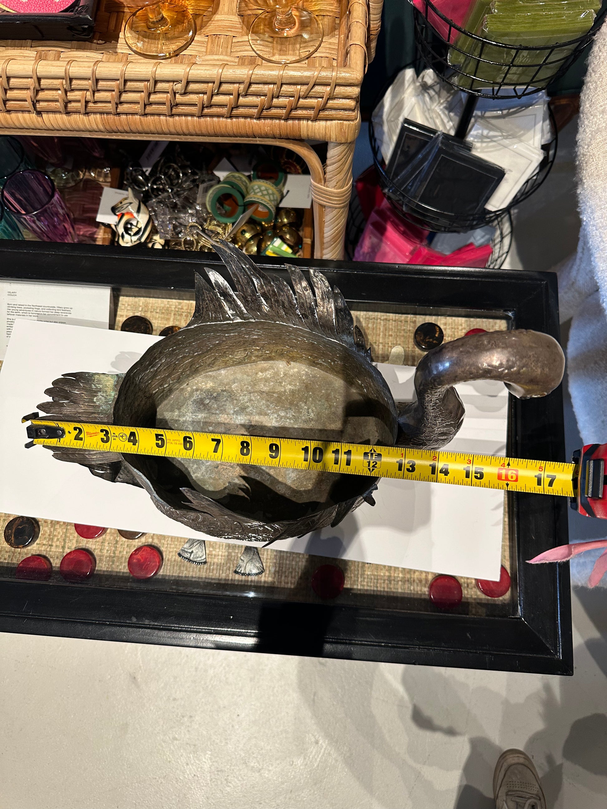 Swan jardiniere measured to about 17 inches long including the tail, shown in a shop setting