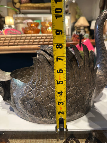 Silver-plated swan jardiniere beside a tape measure showing body height of about 7 inches