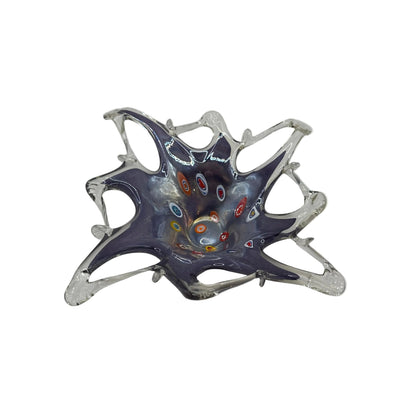 Angled view of Murano-style lavender glass dish with millefiori canes and pulled clear points
