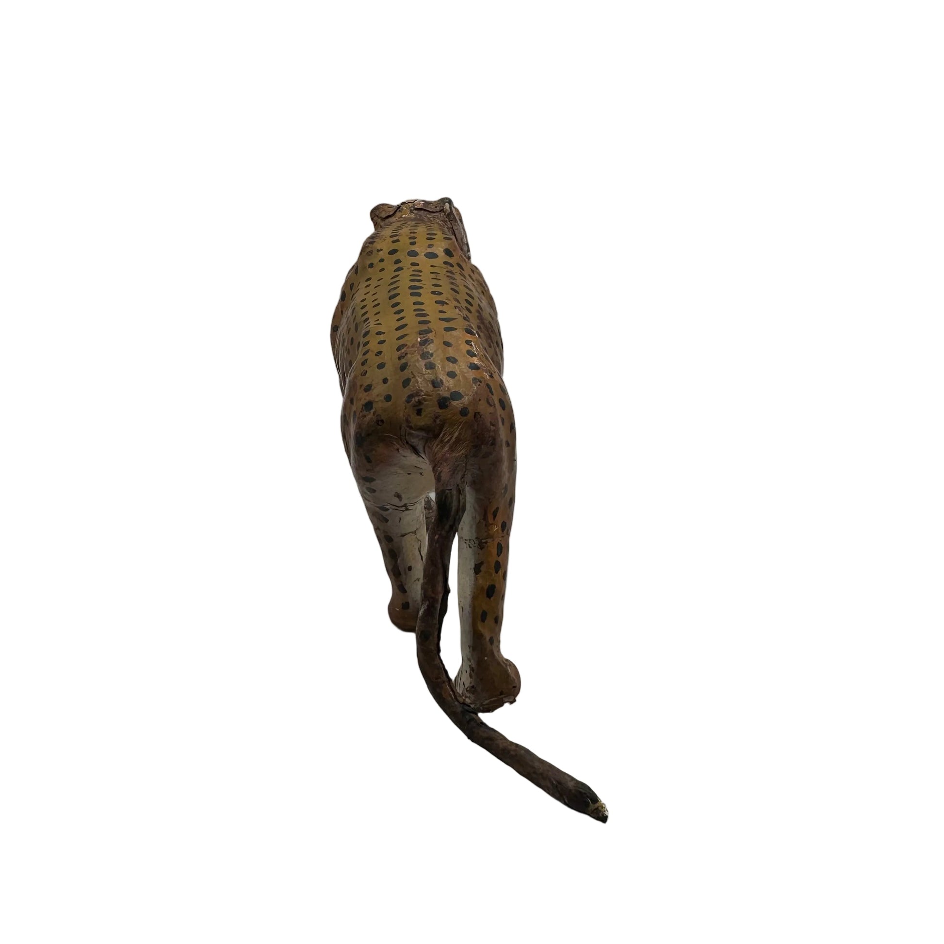 Vintage leather leopard figure viewed from behind, spotted back and long curving tail
