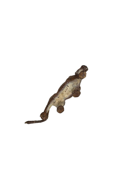Underside of vintage leather leopard figure showing pale belly and four limbs