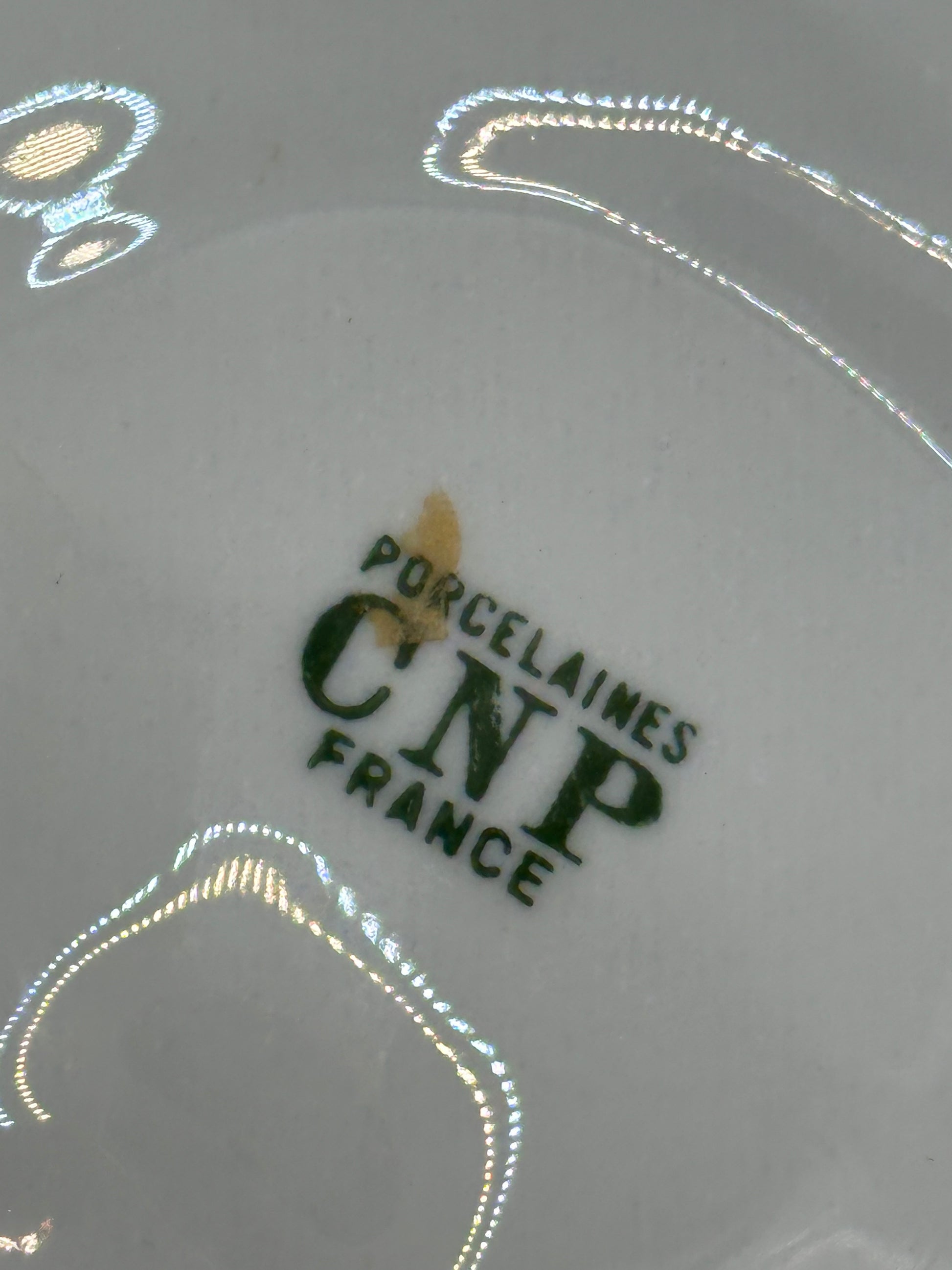 Close-up of maker's mark on oyster dish reading Porcelaines CNP France