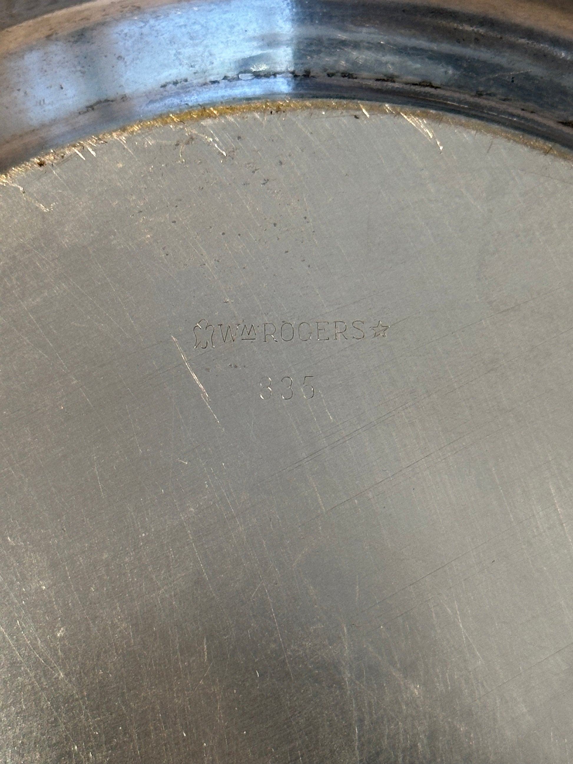 Close-up of 'Wm Rogers 835' maker's mark stamped on bowl underside