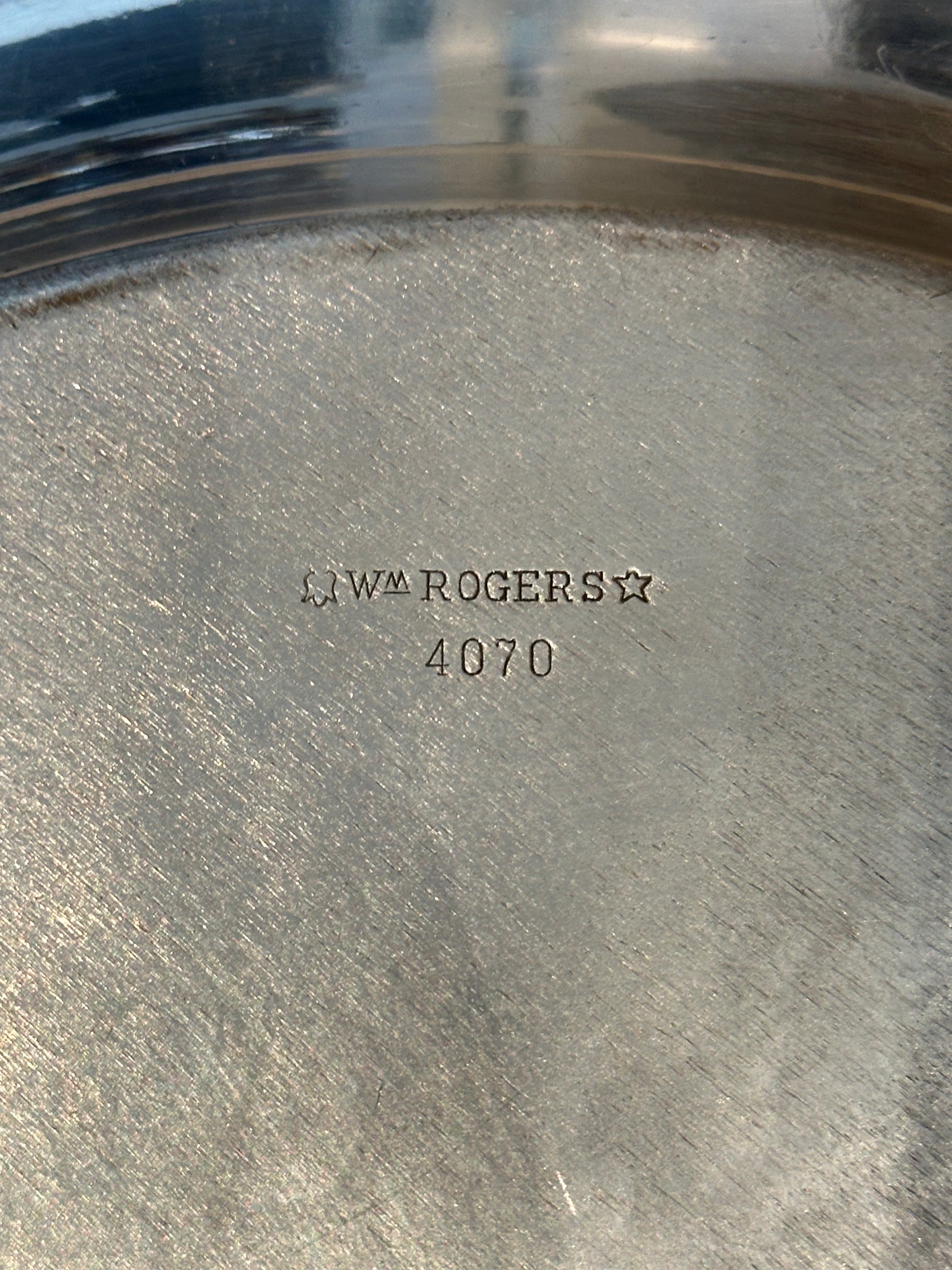 Close-up of 'Wm Rogers 4070' maker's hallmark stamped on tray underside