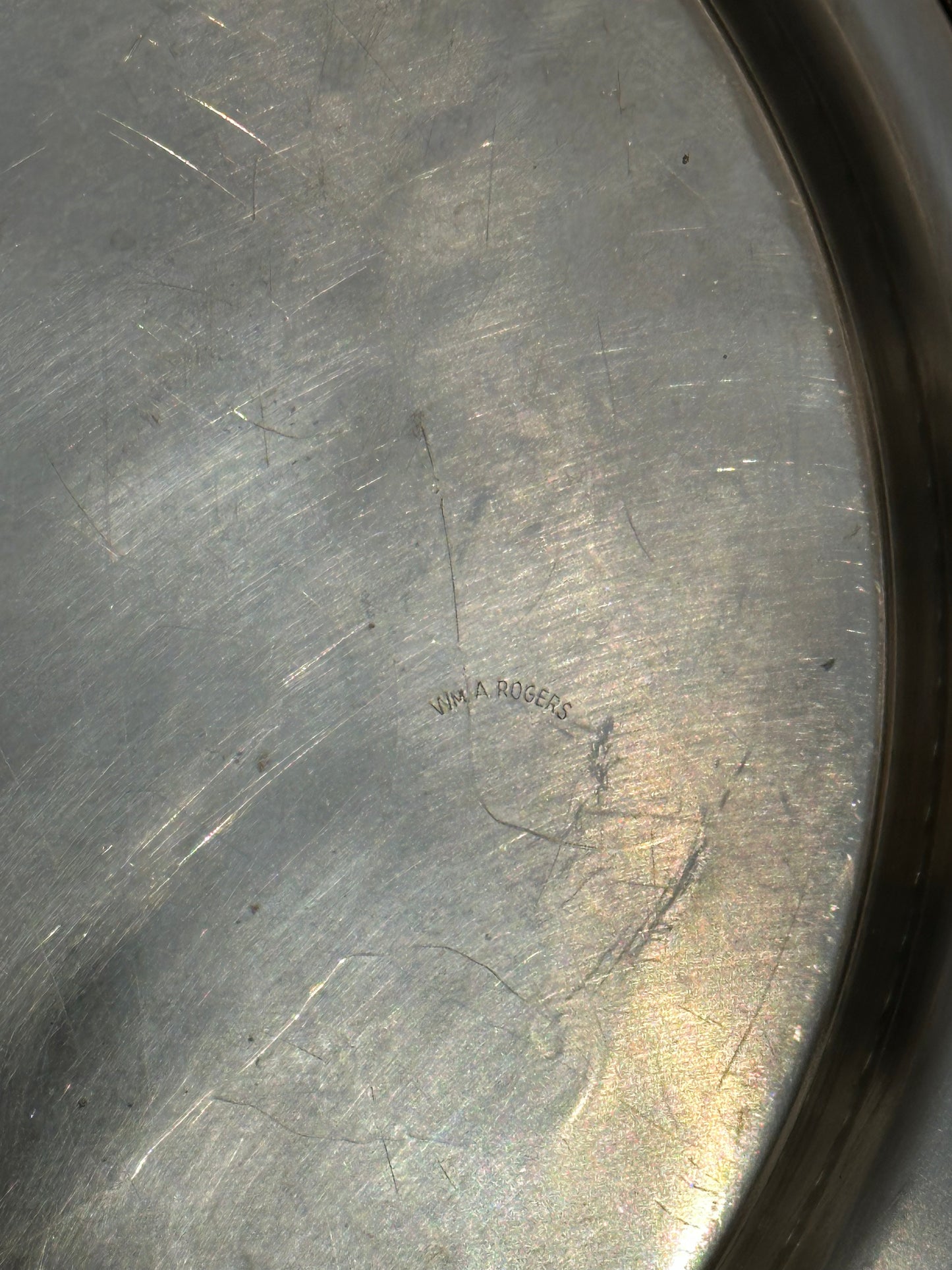 Close-up of 'Wm. A. Rogers' maker's mark engraved on back of silverplate tray